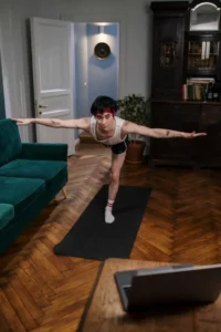 Online Fitness Coaching | Personalized Plans | Sculpted by the Gods 9 slim man doing yoga stretches on yoga mat at home 11 768x1151 1